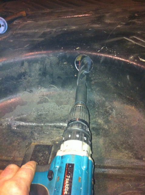 drilling out the hole already in the chassis to take the tube for the rear spring mount