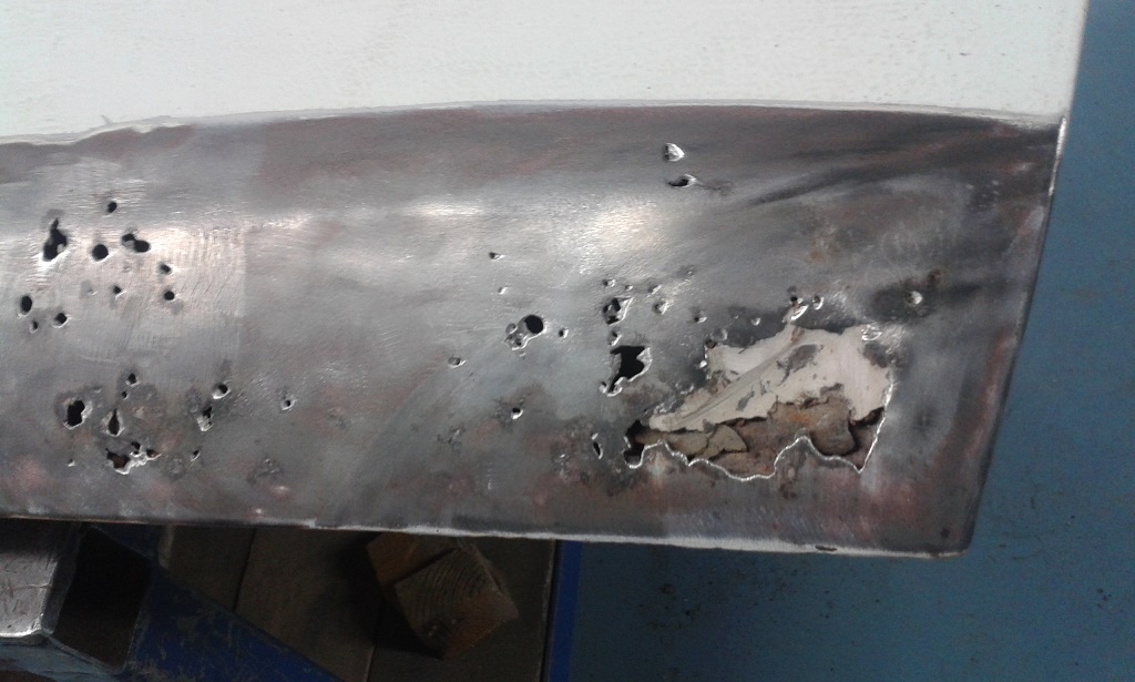 Bottom front of Passenger door.